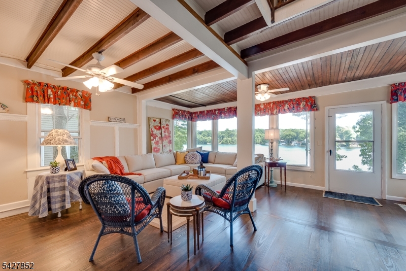 330 Lakeside Avenue Hopatcong, NJ 07821 - Photo 3 of 15 a dining room with furniture a chandelier and wooden floor