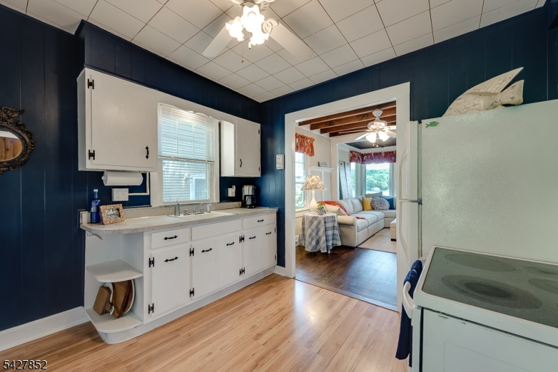 330 Lakeside Avenue Hopatcong, NJ 07821 - Photo 7 of 15 a kitchen with sink cabinets and wooden floor