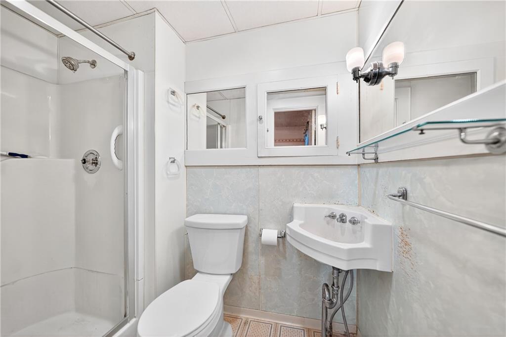 219 Meridian Road Butler, PA 16001 - Photo 22 of 39 a white toilet sitting next to a bathroom sink