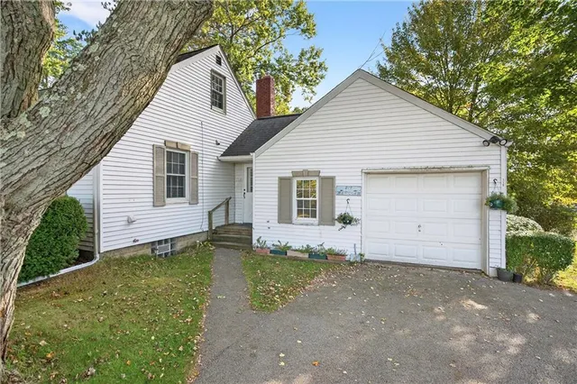 a view of a house with a yard and garage