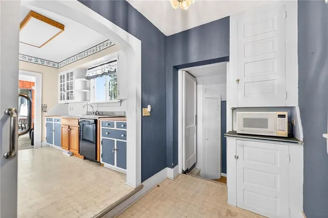 a kitchen with stainless steel appliances kitchen island granite countertop a refrigerator a stove and a sink with wooden floor