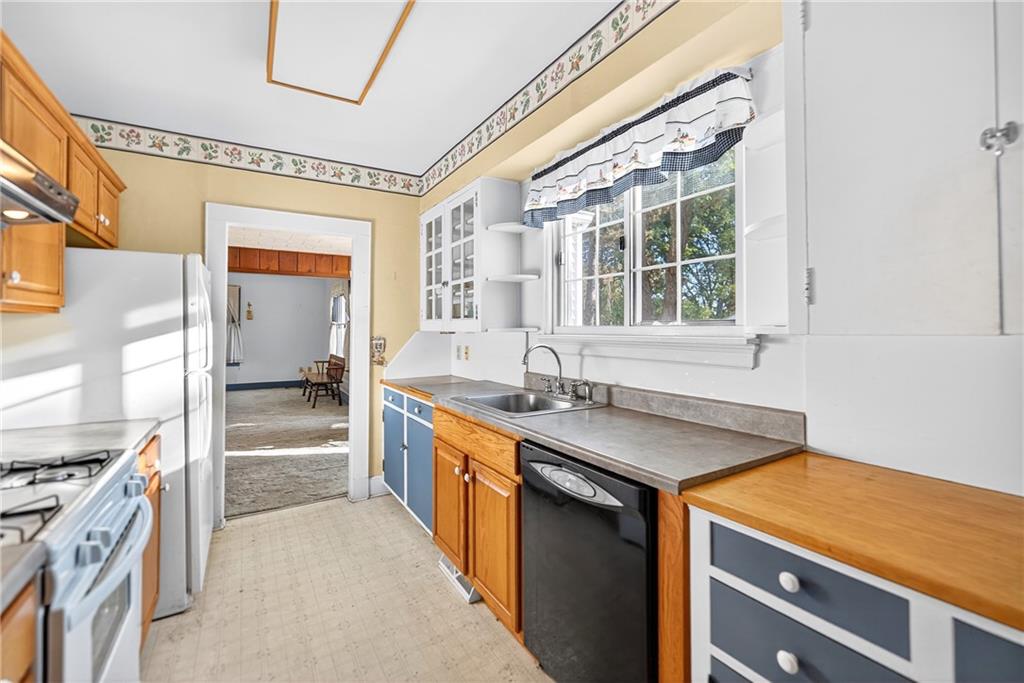 219 Meridian Road Butler, PA 16001 - Photo 8 of 39 a utility room with stainless steel appliances granite countertop a sink and a stove