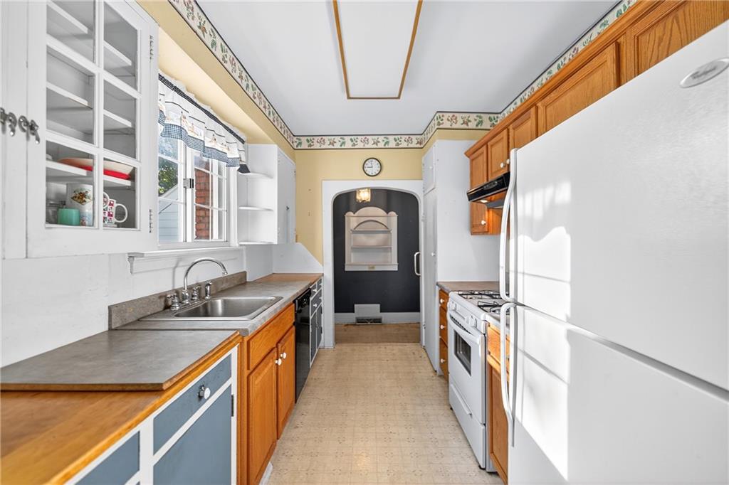 219 Meridian Road Butler, PA 16001 - Photo 9 of 39 a hallway with a sink a washer and dryer