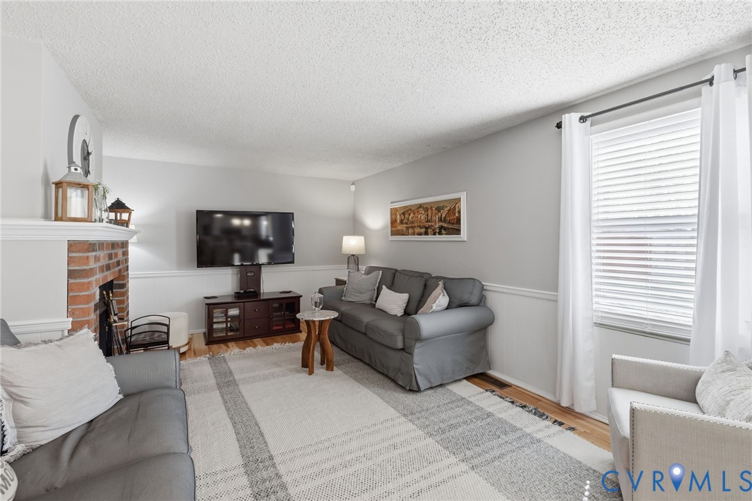 9643 Snowhill Road Richmond, VA 23235 - Photo 12 of 30 a living room with furniture a flat screen tv and a window