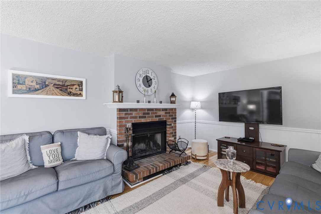 9643 Snowhill Road Richmond, VA 23235 - Photo 13 of 30 a living room with furniture and a fireplace