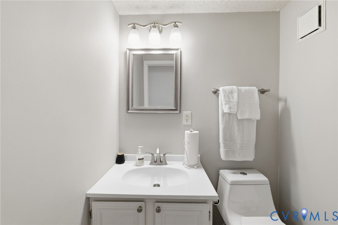 9643 Snowhill Road Richmond, VA 23235 - Photo 14 of 30 a bathroom with a sink toilet and mirror