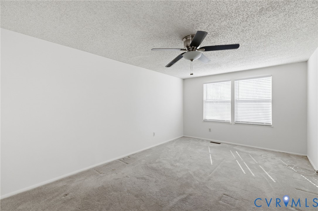 9643 Snowhill Road Richmond, VA 23235 - Photo 15 of 30 an empty room with a window and a fan