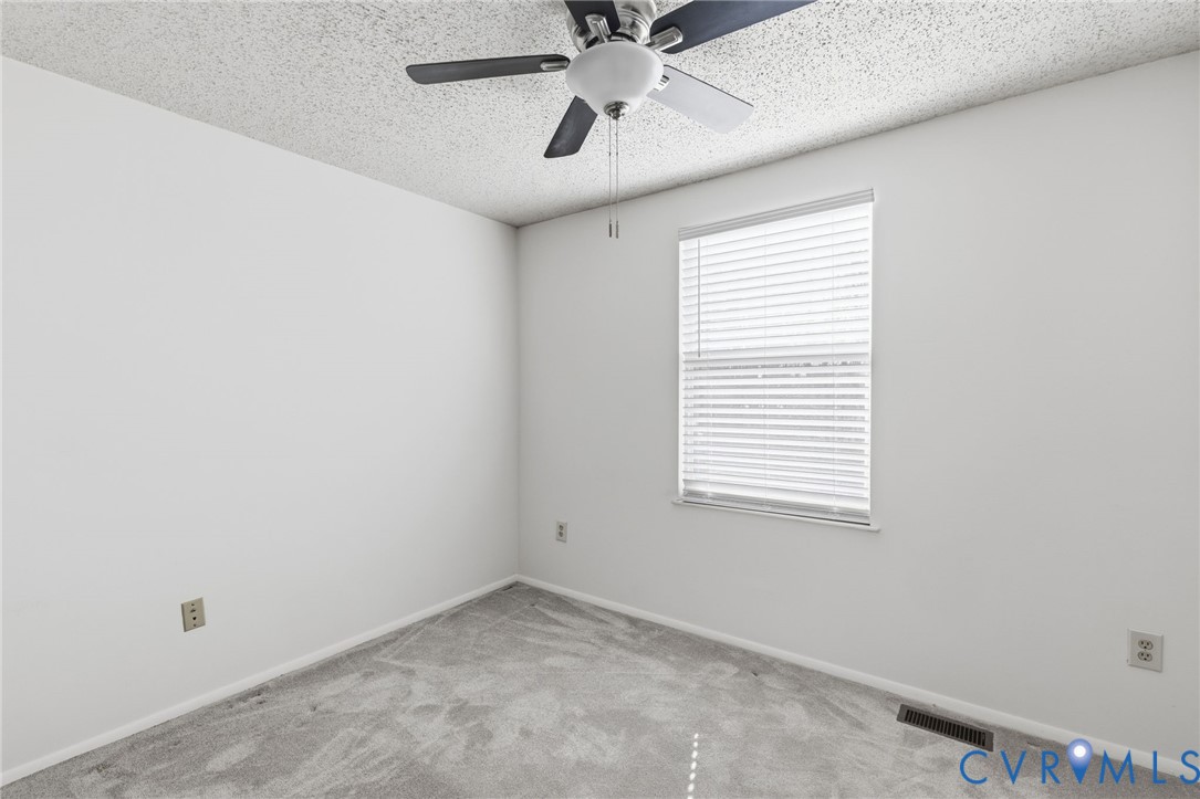 9643 Snowhill Road Richmond, VA 23235 - Photo 18 of 30 an empty room with a window and a fan