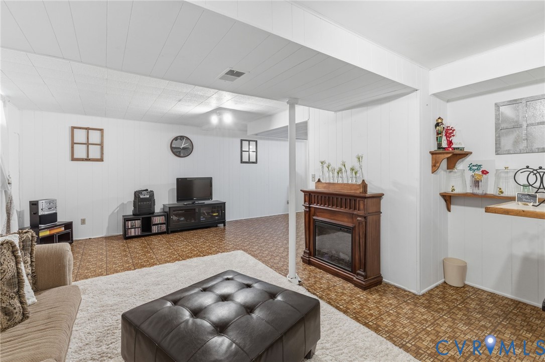 9643 Snowhill Road Richmond, VA 23235 - Photo 24 of 30 a living room with furniture and a fireplace