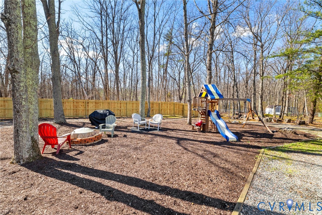9643 Snowhill Road Richmond, VA 23235 - Photo 28 of 30 a view of a backyard with a table and chairs