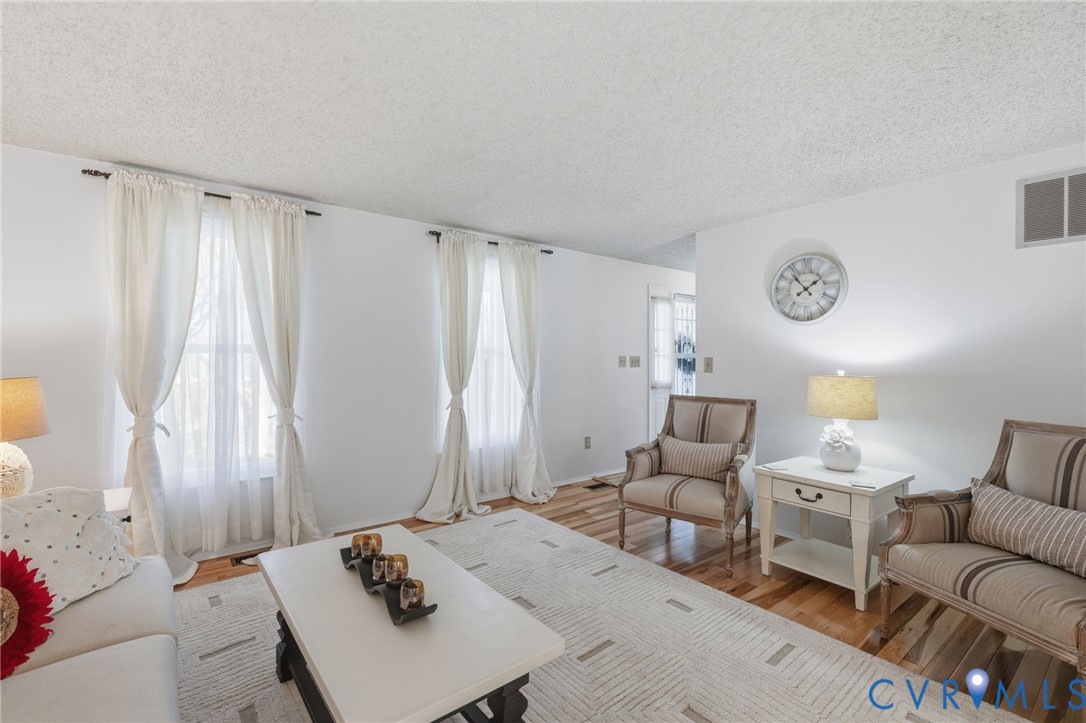 9643 Snowhill Road Richmond, VA 23235 - Photo 4 of 30 a living room with furniture and a table