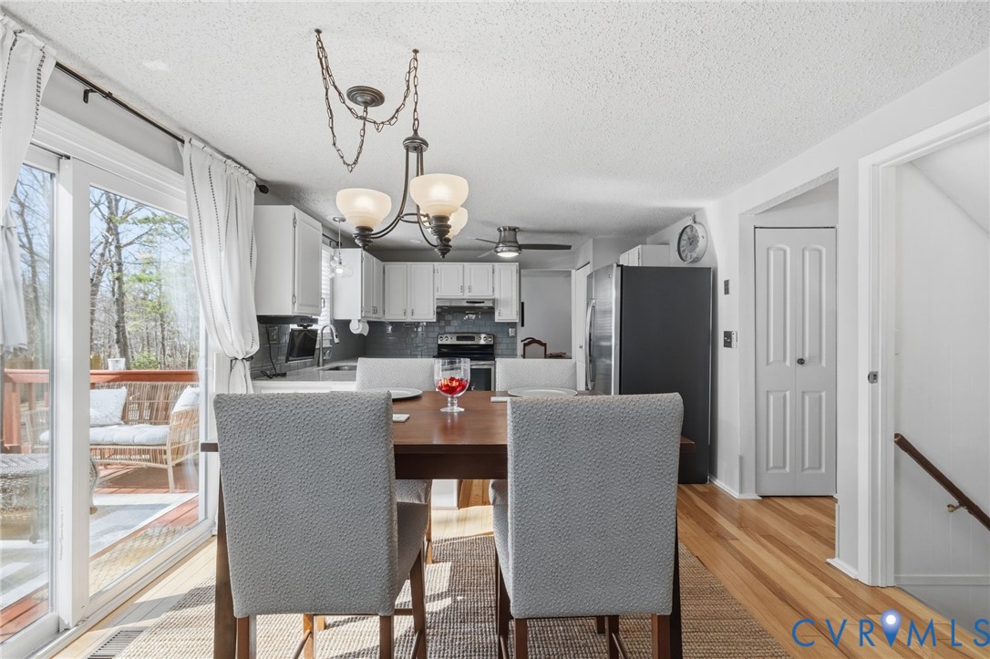 9643 Snowhill Road Richmond, VA 23235 - Photo 10 of 30 a dining room filled with furniture and wooden floor