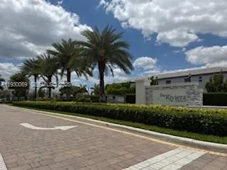 a view of a house with palm trees