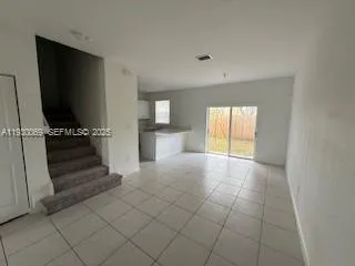 a view of kitchen with furniture and flat screen tv