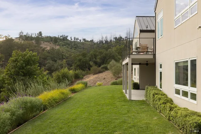 a view of a house with backyard sitting area and garden