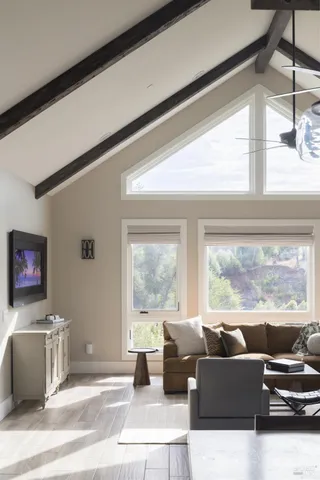 a living room with furniture and large windows