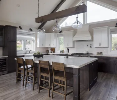 a kitchen with a table chairs stove and wooden floor