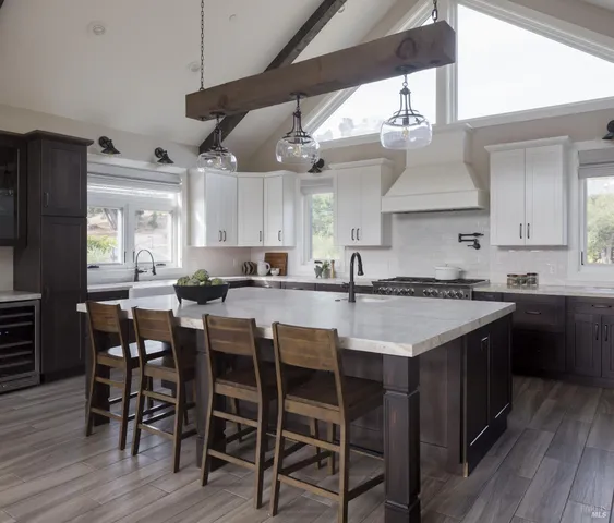 a kitchen with a table chairs stove and wooden floor