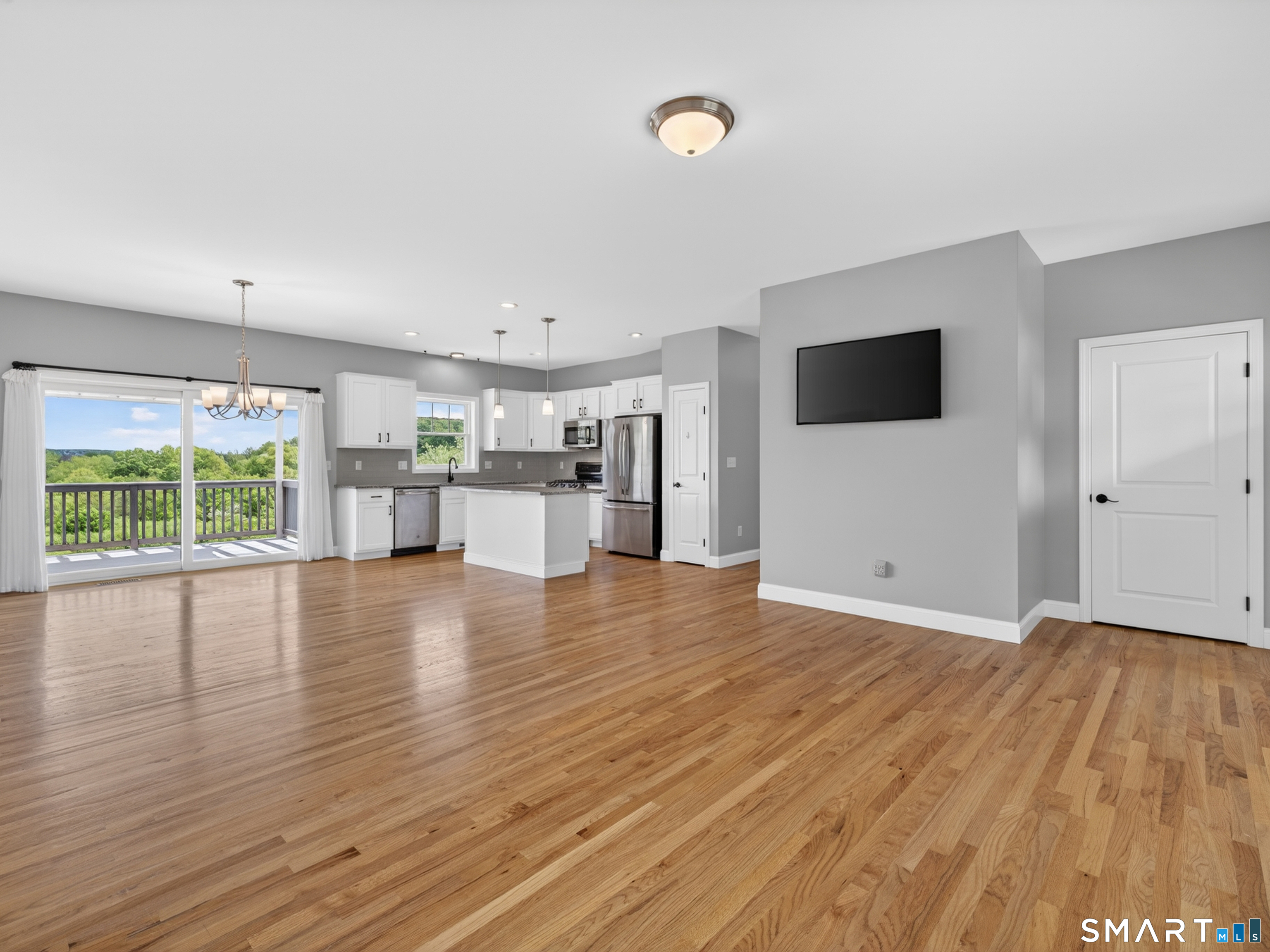 650 Ridgewood Road Middletown, CT 06457 - Photo 9 of 40 a view of a livingroom with furniture flat screen tv and floor to ceiling window