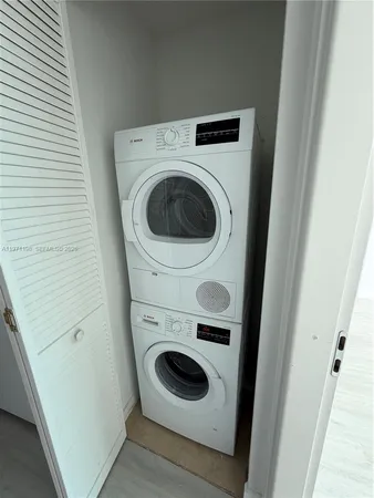 an empty room with wooden floor and closet