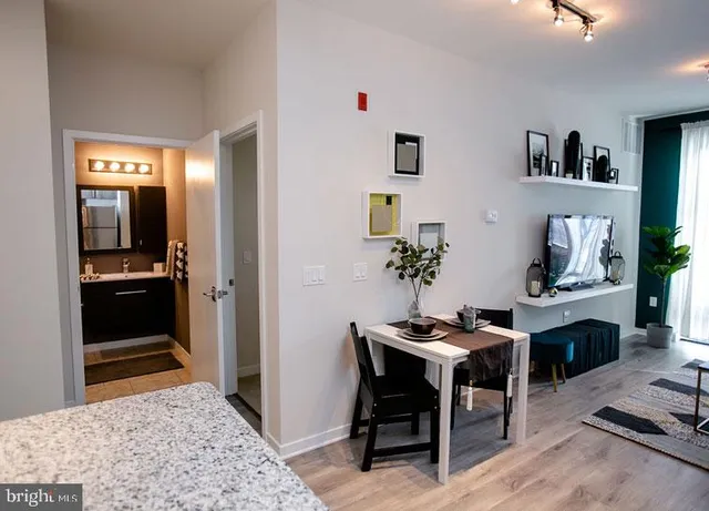 a living room with furniture and view of kitchen
