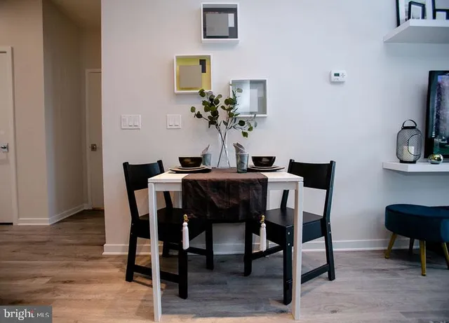 a dining room with furniture and wooden floor