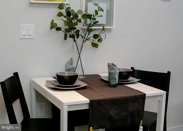 a table with a vase and flowers on it