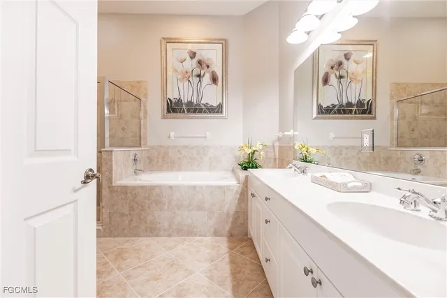 a spacious bathroom with a tub sink and mirror