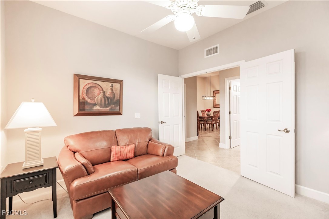 3121 Meandering Way, Unit 201 Fort Myers, FL 33905 - Photo 23 of 39 a living room with furniture and a wooden floor