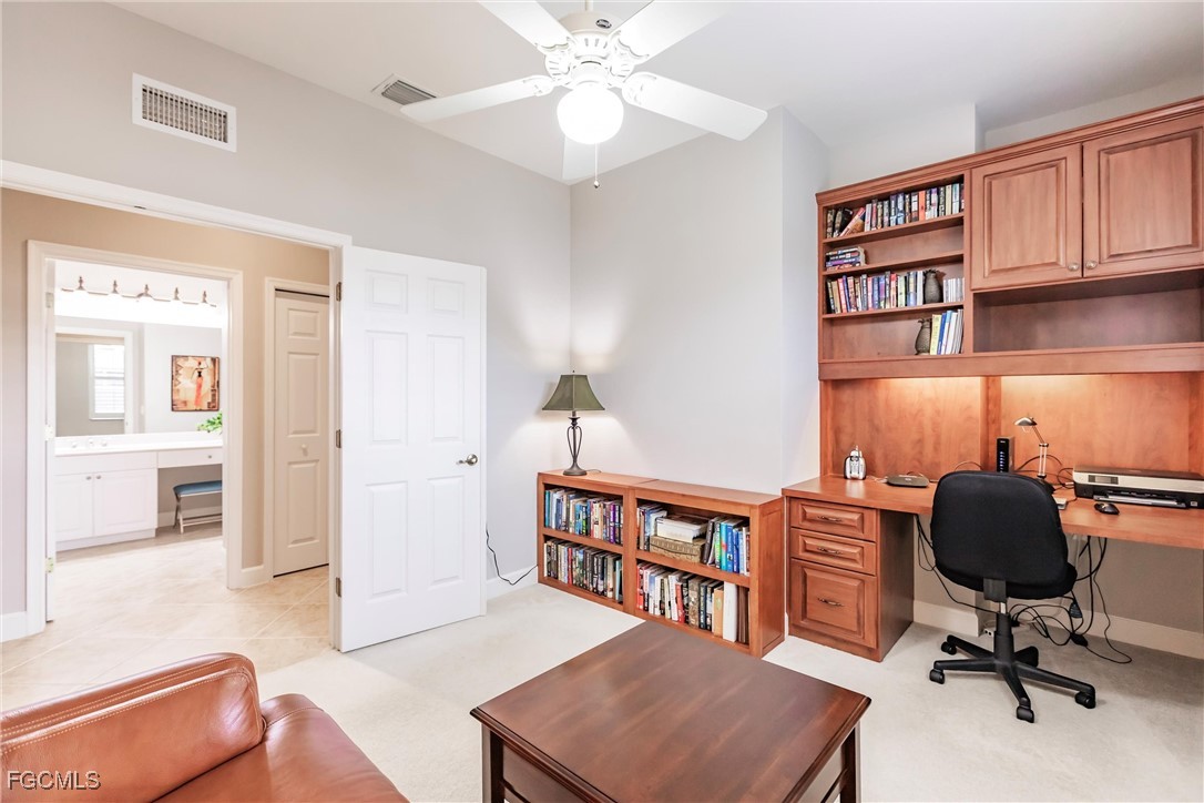 3121 Meandering Way, Unit 201 Fort Myers, FL 33905 - Photo 24 of 39 a view of a workspace with furniture and a bedroom