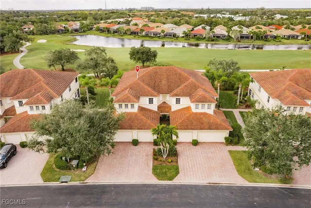 an aerial view of residential houses with outdoor space and river