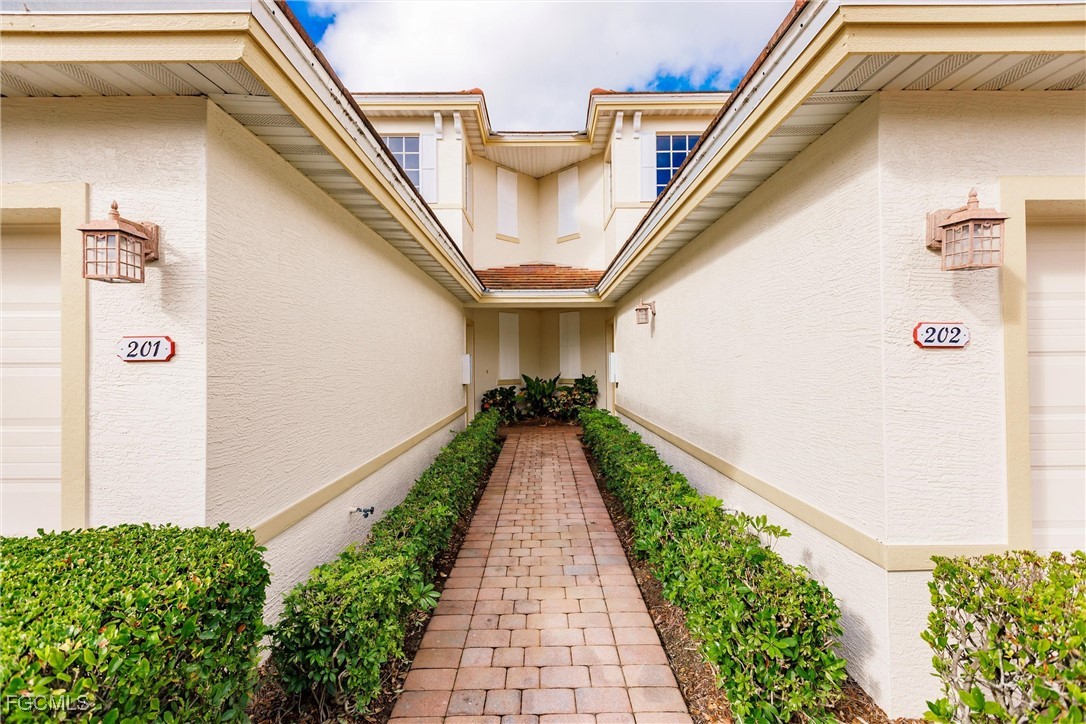 3121 Meandering Way, Unit 201 Fort Myers, FL 33905 - Photo 6 of 39 a view of a pathway with a white house