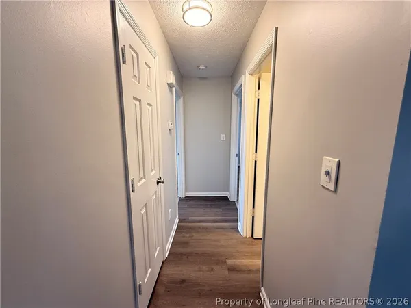 a view of a hallway with wooden floor and entryway