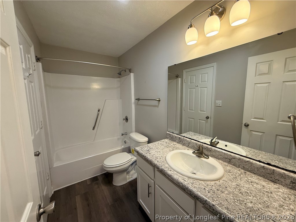 4924 Cameron Road Hope Mills, NC 28348 - Photo 7 of 13 a bathroom with a granite countertop sink toilet and shower