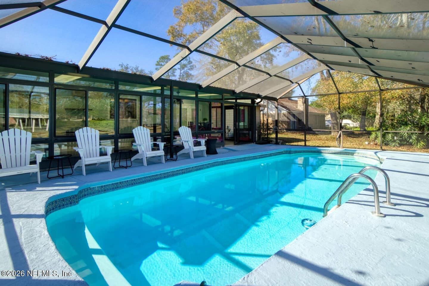 11613 Lake Ride Drive Jacksonville, FL 32223 - Photo 7 of 42 a view of a patio with swimming pool table and chairs