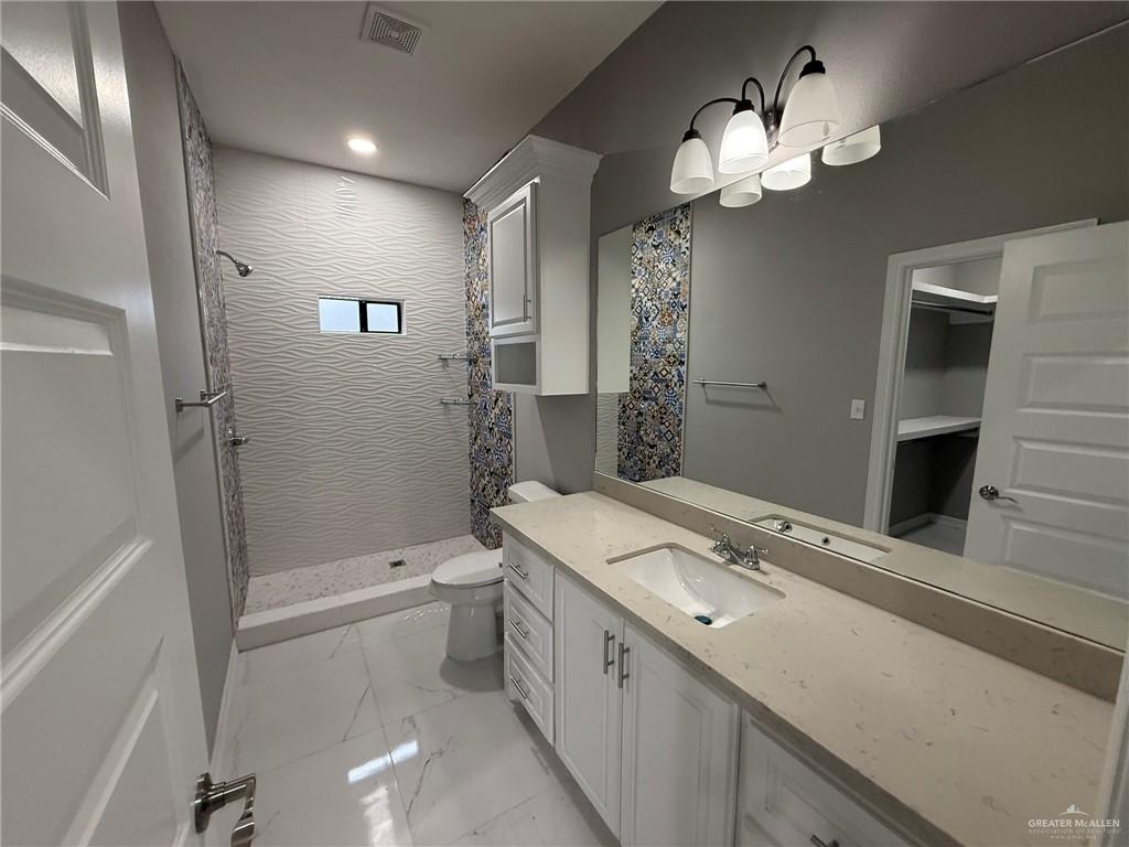 4195 Chapotito Street Rio Grande City, TX 78582 - Photo 5 of 15 a bathroom with a sink a toilet and shower
