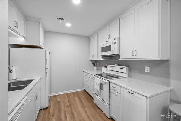 a kitchen with stainless steel appliances a sink stove and refrigerator