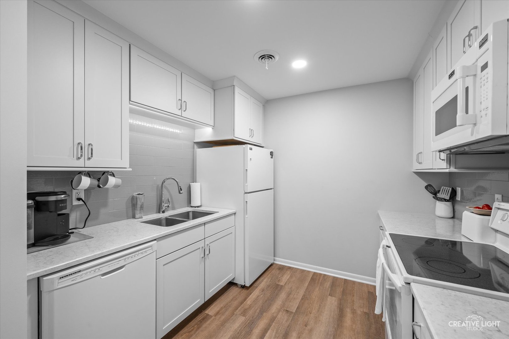 450 West Downer Place, Unit 4C Aurora, IL 60506 - Photo 4 of 16 a kitchen with a sink dishwasher a refrigerator and cabinets