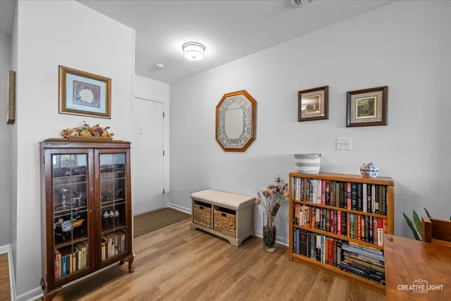 a living room with furniture and a book shelf