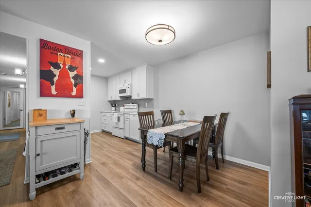 a view of a dining room with furniture and wooden floor