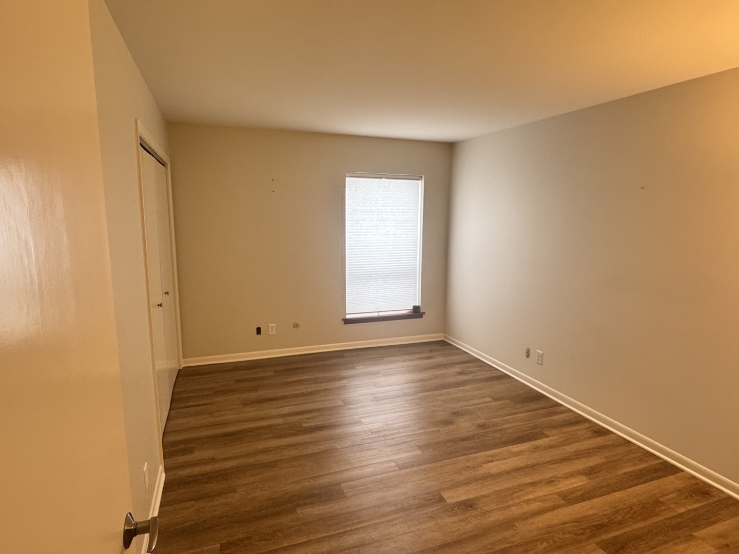 450 West Downer Place, Unit 4C Aurora, IL 60506 - Photo 8 of 16 a view of an empty room with wooden floor and a window