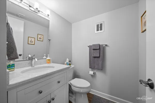 a bathroom with a sink toilet and mirror