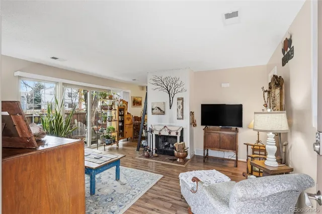 a living room with fireplace furniture and a flat screen tv