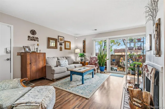 a living room with furniture large window and flat screen tv