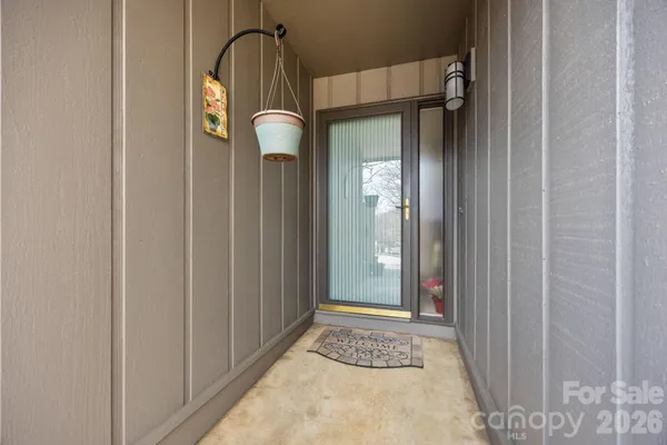 a view of a entryway door with wooden floor