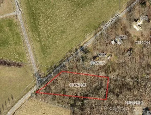 an aerial view of a houses with a yard