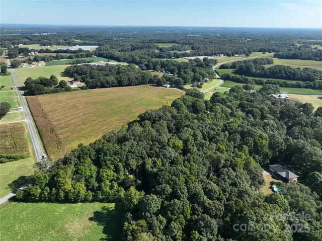 an aerial view of a houses with a yard