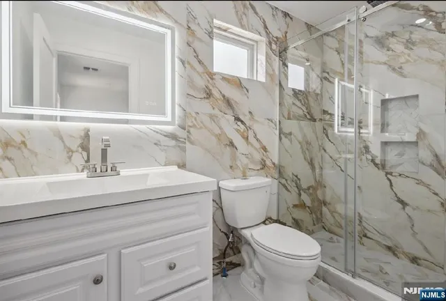 a bathroom with a sink toilet and shower