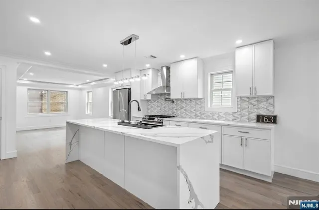 a kitchen with stainless steel appliances granite countertop a sink and cabinets