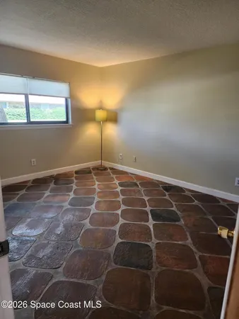 a view of a room with an empty space and a window